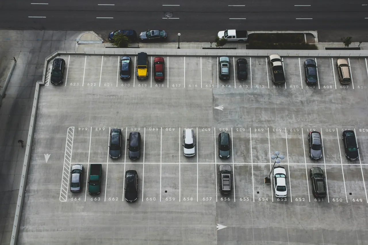 Aerial view of a commercial car park with marked bays