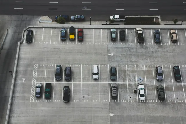 Aerial view of a commercial car park with marked bays